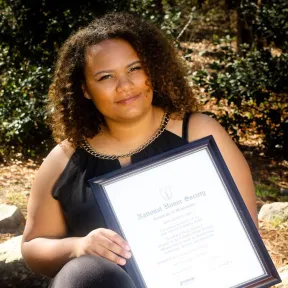 Lexandra, holding National Honor Society Certificate