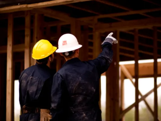 Two men working on construction site