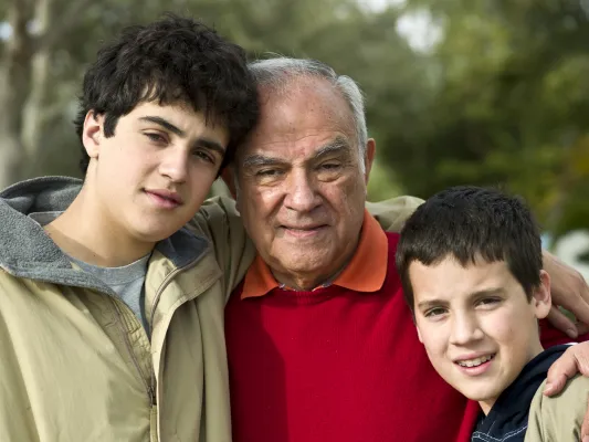 A man stands with two boys