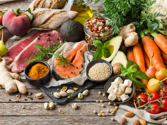 Assortment of grains, vegetables, fruits, and meats laid out on a table