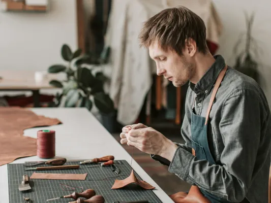 Young man working on a project at a table