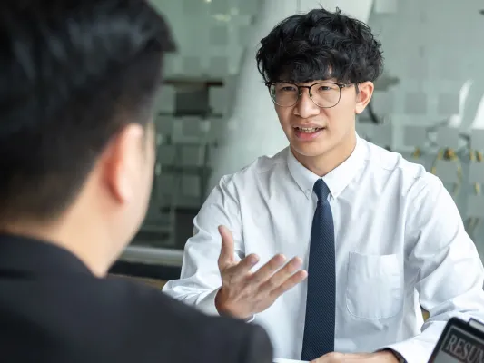 Youth talking to an adult in a work setting