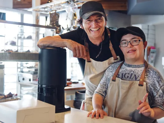Youth with a disability and an adult employer at a coffee shop