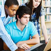 Group on three working on a computer