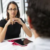 Woman with a tablet talking to a man