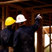 Two men working on construction site