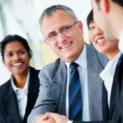 Men shaking hands in a meeting