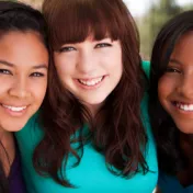 Three young women smiling