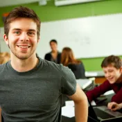 Young man standing in classroom