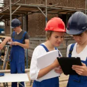 Two young women working on a construction site