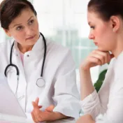 Doctor speaking to young woman