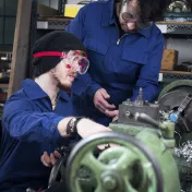 Two men engaged in manual labor