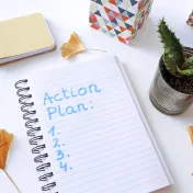 Photo of notebook, pen, and plant on table