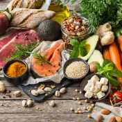 Assortment of grains, vegetables, fruits, and meats laid out on a table