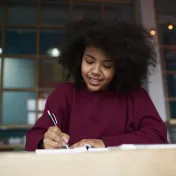 Young woman doing homework at desk