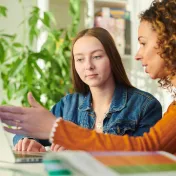Youth and adult working at a laptop together