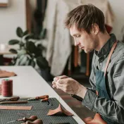 Young man working on a project at a table