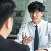 Youth talking to an adult in a work setting