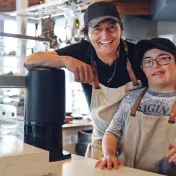 Youth with a disability and an adult employer at a coffee shop